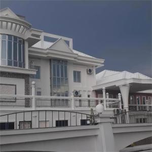 a large white house with a large balcony at Magnificent White House Semporna by The Minimalist in Semporna