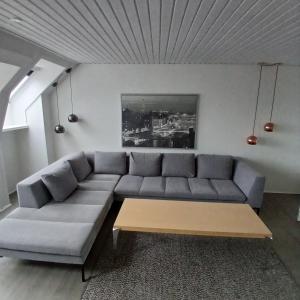 a living room with a couch and a coffee table at Eksklusiv stort boende i Fredrikshavn in Frederikshavn