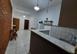 a kitchen with a sink and a counter top at Pousada Villa in Piquete +32 photos