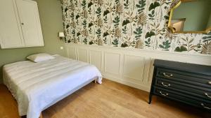 Le Moulin - Appartement cosy proche plage - Veules-les-Roses في فول-لي-روز: غرفة نوم بسرير ومرآة وخزانة +5 صور