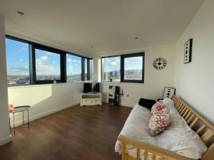 a large room with a bed and some windows at Nottingham Central Accommodation in Nottingham