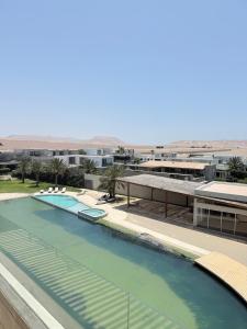 Apartamento Vista Reserva y Playa en Paracas في Santo Domingo: منظر لحوض سباحة أعلى مبنى