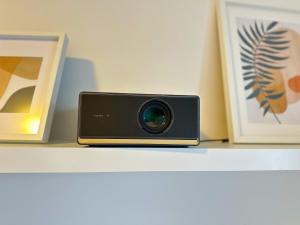 a camera sitting on a shelf with pictures at New Modern Home-Projector-Nespresso-View-Balcony in Komárov