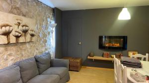 a living room with a couch and a fireplace at El Rincon De Los Abuelos in Tudela de Duero