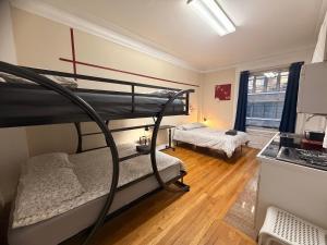 a room with two bunk beds and a kitchen at JGSTAY - Koreatown in New York