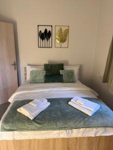 a bedroom with a bed with two towels on it at Demis Sea Breeze Apartment in Artemida