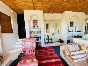 a living room with a couch and a chair at Cape Holly Beach House in Pringle Bay
