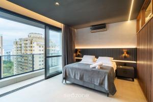 a bedroom with a bed and a large window at TVT - Luxury studios in the center of Florianópolis in Florianópolis +68 photos