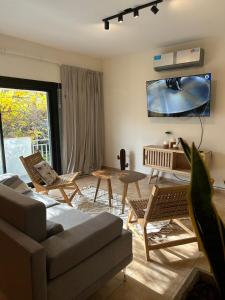 Μια τηλεόραση ή/και κέντρο ψυχαγωγίας στο Casa Frida - Alojamiento exclusivo para Mujeres -