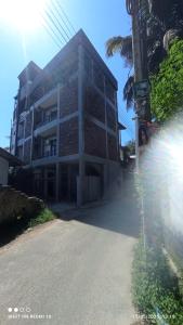 a building on the side of a street at Blue Sky Villa 02 Ahangama in Ahangama +3 photos