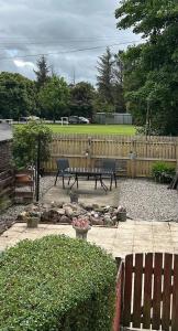 a patio with a picnic table and a fence at Loch Lomond Apartment in Alexandria +15 photos