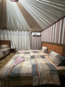 a bedroom with a bed in a tent at Natalie Wadi Rum camp & Jeep tour in Wadi Rum +142 photos