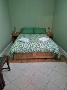 a bedroom with a bed with two towels on it at The Ferns in Mitcheldean