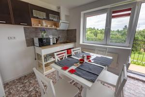 a kitchen and dining room with a table and chairs at Agroturystyka Na górce in Węgierska Górka +5 photos