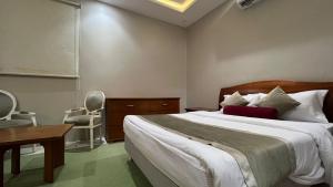 Postel nebo postele na pokoji v ubytování شقق واحة بيروت