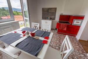 a dining room with a table and a kitchen at Agroturystyka Na górce in Węgierska Górka