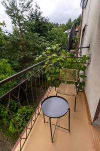 a balcony with two chairs and a table at Agroturystyka Na górce in Węgierska Górka