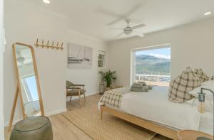 a bedroom with a bed and a large window at Ocean Villa Views Fish Hoek in Glencairn