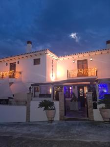 a large white building with a balcony at night at ''EPAVLIS boutique GALAXIDI'' in Galaxidhion