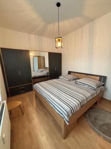 a bedroom with a large bed and a mirror at Haus an der Linde in Bad Essen