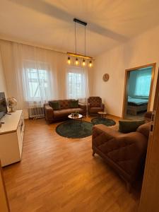 a living room with a couch and a table at Haus an der Linde in Bad Essen