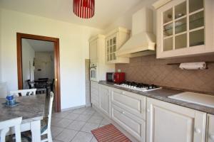 a kitchen with white cabinets and a counter top at Casa DiVa in Terni