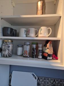 a shelf with cups and other items in a pantry at The Ferns in Mitcheldean