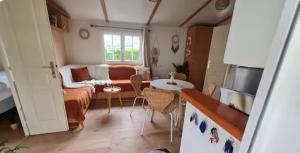 a living room with a couch and a table at La casa du clos in La Bernerie-en-Retz
