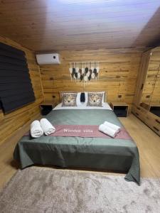 a bedroom with a large bed in a wooden room at Wooden villas in Chrysoupolis +18 photos
