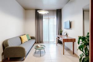 a living room with a couch and a table at Dogpound Hotel in Athens