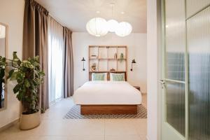 a bedroom with a bed and a potted plant at Dogpound Hotel in Athens +52 photos