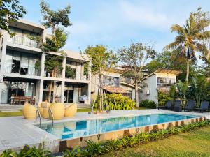 an image of a house with a swimming pool at Nuraai River Chalets in Ambalangoda