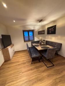 a dining room with a table and a couch at Appartement Steinbergrose in Leogang +9 photos
