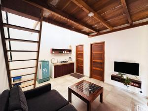 a living room with a couch and a table at Nuraai River Chalets in Ambalangoda