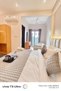 a hotel room with a large bed and a room at Vilaasitaa Family Suites in Indore