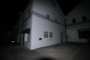 a large white building at night with a parking lot at One Bedroom Flat With Free parking in Acton in London