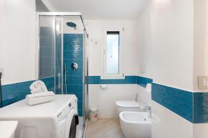 a bathroom with a toilet sink and a washing machine at Nanninella Guest House in Minori +21 photos