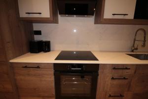 a kitchen with a sink and a counter top at One Bedroom Flat With Free parking in Acton in London +23 photos