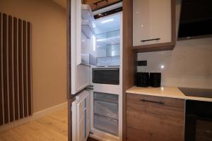 an empty refrigerator with its door open in a kitchen at One Bedroom Flat With Free parking in Acton in London