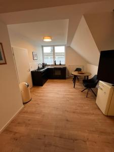 an attic room with a kitchen and a table at Luxus Ferien Apartment vS in Marburg an der Lahn +23 photos