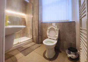 a bathroom with a toilet and a sink at Kop View in Liverpool +62 photos