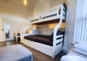 a bedroom with two bunk beds in a room at Kop View in Liverpool