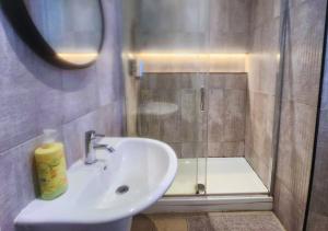 a bathroom with a sink and a shower at Kop View in Liverpool
