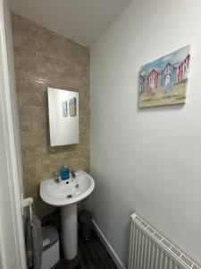 a bathroom with a white sink in a room at Coastal Retreat - Skegness in Skegness +20 photos