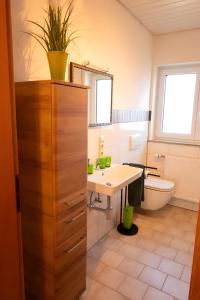 a bathroom with a sink and a toilet at Ferienwohnung Familie Löffler in Ostrach +14 photos