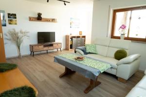 a living room with a couch and a coffee table at Ferienwohnung Familie Löffler in Ostrach