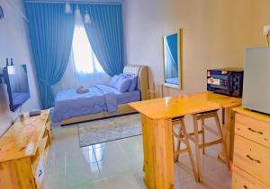 a living room with a couch and a table at NonaStudio Myra Park Nilai 3 in Nilai