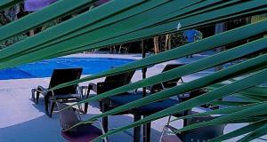 a group of chairs sitting next to a swimming pool at Hotel La Marsu in Cap Skirring +8 photos