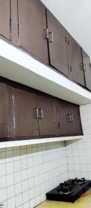 a stove top on a shelf in a kitchen at Indraprastha BNB Home in New Delhi