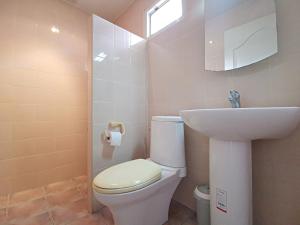 a bathroom with a white toilet and a sink at Pool Villa 91 in Ban Nong Pru